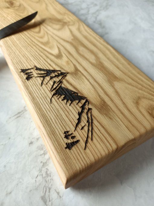 gravure d'une montagne sur une planche à découper en bois